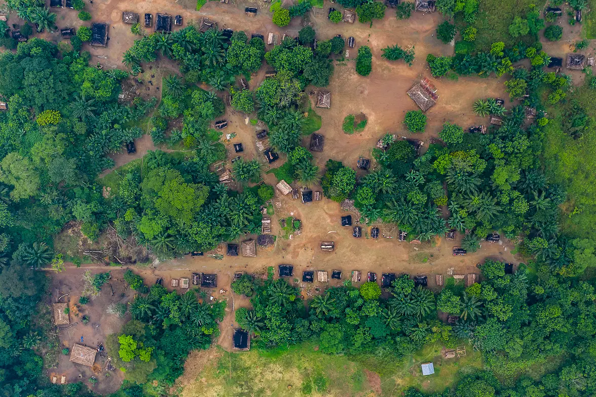 Aerial view of a village in the rain forest where Synchronicity Earth works with partners